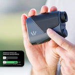 Hand holding a rangefinder with a blurred background