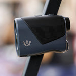 Black laser rangefinder with a brand logo on a blurred background