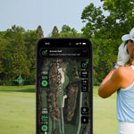 Golfer using a smartphone app on a golf course with trees in the background