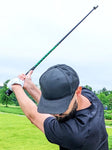 Golfer using a speed stick training aid with the Blast motion sensor
