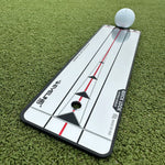 Golf practice mirror with a golf ball on a green grass background
