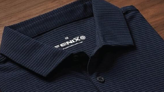 Fenix clothing and accessories on a wooden surface with visible branding.