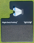 Top-down view of the Flight Deck Putting mat with white and blue alignment guide inserted and anti-slip foot pad visible below the branding