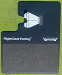 Overhead view of the Flight Deck Putting mat with white alignment guide inserted, showing the branded stance pad and textured foot grip zone