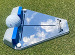 Flight Deck Putting Tour Soft Kit alignment guide on a putting green with a golf ball seated between the blue gate blocks and alignment lines visible on the mirrored surface