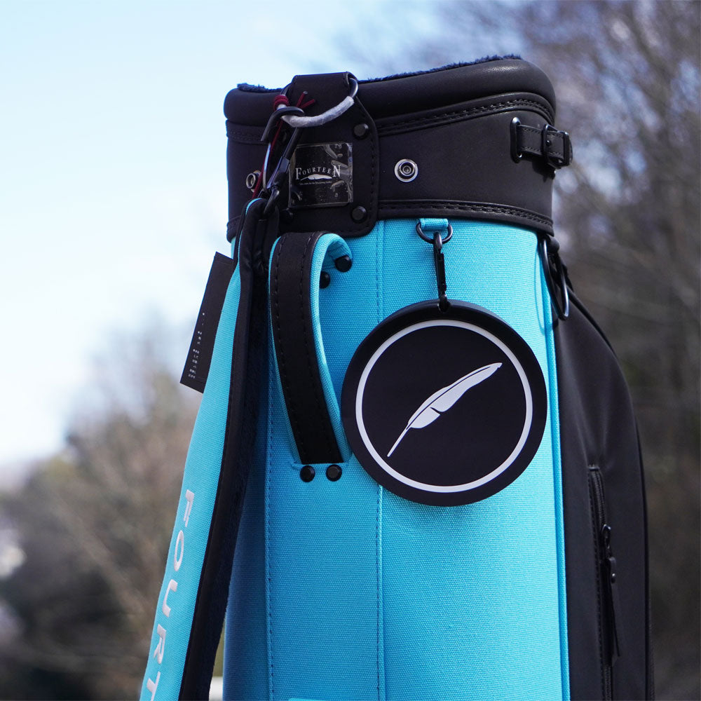 Fourteen bag tag hung clipped on a stand bag 