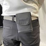 Rangefinder case hung on a man's belt 