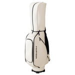 Side profile of the Fourteen Golf caddie bag in cream and black colourway on white background showing the hood, pocket layout, and Fourteen branding
