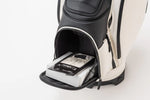 Open lower pocket of the Fourteen Golf caddie bag in black and white colourway showing a boxed Fourteen glove stored inside the spacious zippered compartment
