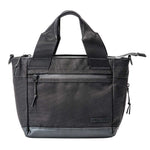 Fourteen Golf black cart tote bag front view on white background showing dual top handles, front zip pocket with gunmetal hardware, FOURTEEN rubber badge, PU leather base trim, and side zip expansion pockets with paracord pulls