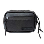 Fourteen Golf black round pouch flat lay on white background, front view showing dual zipper closure, front slip pocket, PU leather accent strip, FOURTEEN rubber badge, and paracord zipper pulls