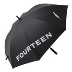 Fourteen Golf black golf umbrella fully open at angle showing large FOURTEEN wordmark and feather logo in white on canopy, with black shaft and foam grip handle, on white background