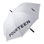 A white golf umbrella with the brand name 'FOURTEEN' printed on the canopy, with a black handle and accents.