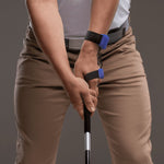 Person holding a golf club with a HackMotion Sensor 4 on the grip and equipment.