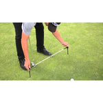 Man using the adjustable alignment sticks on the green