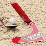 A red and white golf training aid called Eyeline Bunker Pro System, placed in a bunker with a golf ball and a club to demonstrate its use.