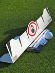 EyeLine Golf Edge Putting Rail on grass with golf ball positioned at the tee peg guide and alignment target visible on the rail face