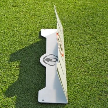 A white Eyeline Golf Edge Putting Rail with a 70-degree angle, placed on a green surface. It has a powder coat finish and features a logo and markings on the face.
