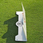 A white Eyeline Golf Edge Putting Rail with a 70-degree angle, placed on a green surface. It has a powder coat finish and features a logo and markings on the face.