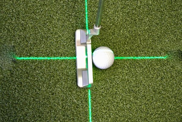 Overhead view of putter and golf ball centred on a green cross-hair laser line projected by the EyeLine Golf Groove Putting Laser