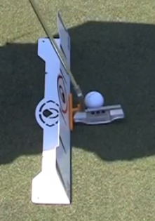 Overhead view of the EyeLine Golf Putter Guide on a mallet putter at address behind a golf ball, with the Edge alignment training aid positioned alongside