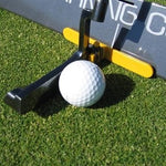 A golf putter guide attached to a mallet, with a white golf ball in the center and a green background.