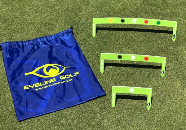 EyeLine Golf Putting Path Gates 3-piece set in three sizes laid out on the green alongside the blue EyeLine Golf drawstring carry bag