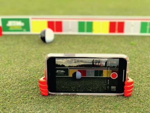 Close-up of MyRoll ball striking the EyeLine Golf SloMo Screen, showing the two-tone ball design used to reveal topspin and backspin