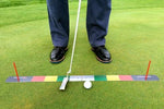 Front-facing view of golfer at address over the EyeLine Golf Stroke Meter on the green, putter centred on the colour-coded mat