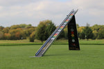 EyeLine Golf Sweet Roll Rail System standing upright on the green, showing the angled ramp and colour-coded strike zones against an autumn course backdrop