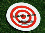 Eyeline Golf Target Hole disc laid flat on grass showing full bullseye design, used as a visual target for short game practice drills