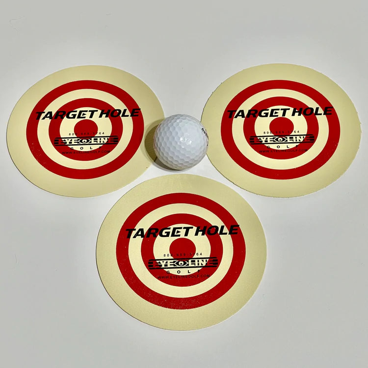 Three yellow golf target holes with red and black text indicating the target hole brand, Eyeline, and a golf ball placed in the center of the holes.