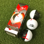 Three golf balls with a semi-black, semi-white design and a red impact ball line, packaged in a box with a similar design.