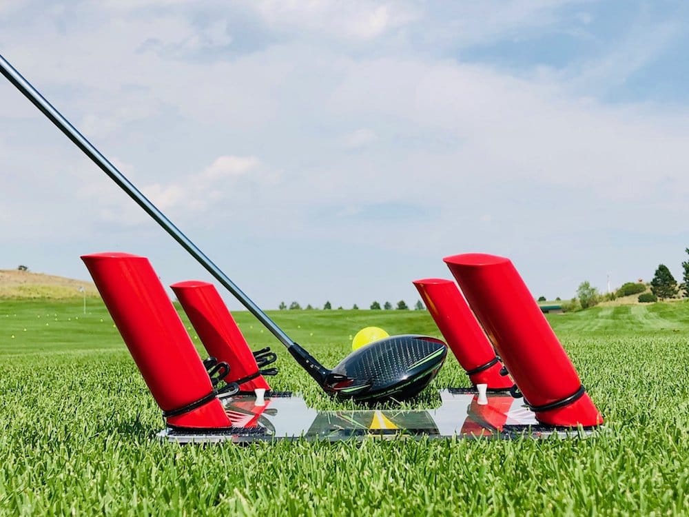 Eyeline Speed Trap 2.0 swing path training gate with red foam barriers and mirror base, driver positioned at address on golf course