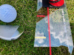 Close-up of Eyeline Speed Trap_2.0 showing chipping, pitching, and full swing alignment markers beside a club and golf ball