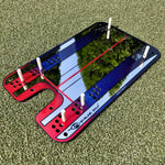 A Groove putting mirror with red and blue colors, designed for golf training, placed on a green surface.